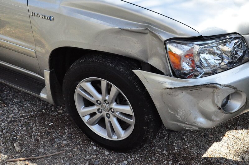 Dents in front right of silver hybrid car after car accident