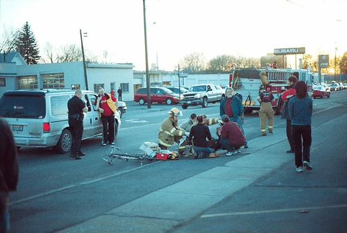 Emergency responders helping pedestrian who someone accidentally hit with their car.
