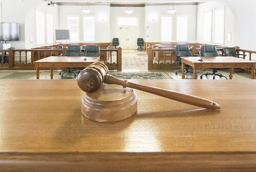 Gavel on Judge's bench with empty courtroom in the background