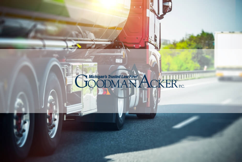 Truck Driving Down Highway with Goodman Acker Logo Emblazoned on Picture