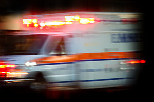 Blurred Image of an Ambulance Racing Down a Road at Night