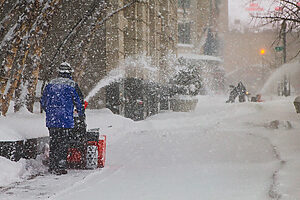 Michigan Man Using Toro Snowblower on Winter Road
