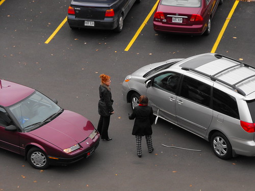 Two Drivers Debating in a Parking Lot at the Scene of a Car Accident