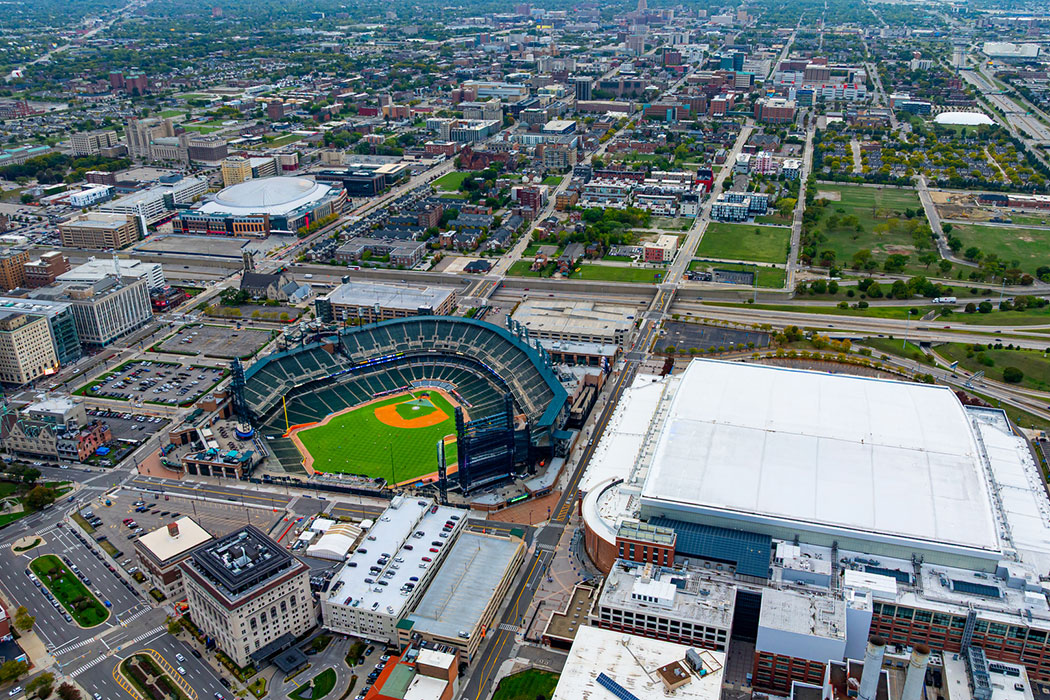 Drone aerial view of Downtown Detroit showing Comerica Park and Little Caesars Arena, representing event-day traffic surges that increase crash risk at nearby intersections.
