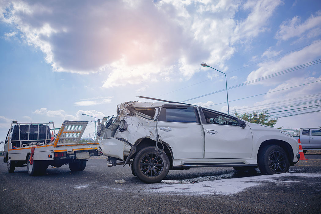 Two damaged vehicles after a serious roadway collision, with drivers waiting for help, representing car accident injury cases in Muskegon, Michigan.
